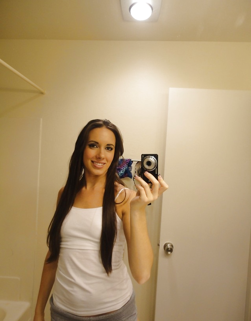 Free Young bitch in white shirt posing in the mirror photos