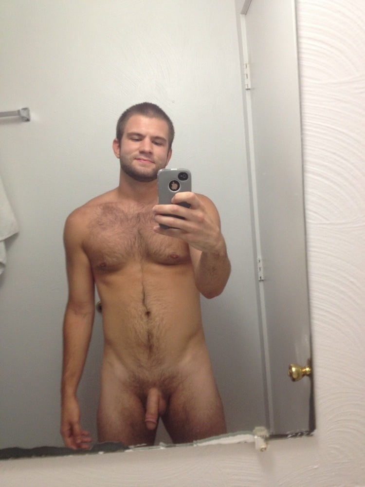 Guy posing nude in front of mirror