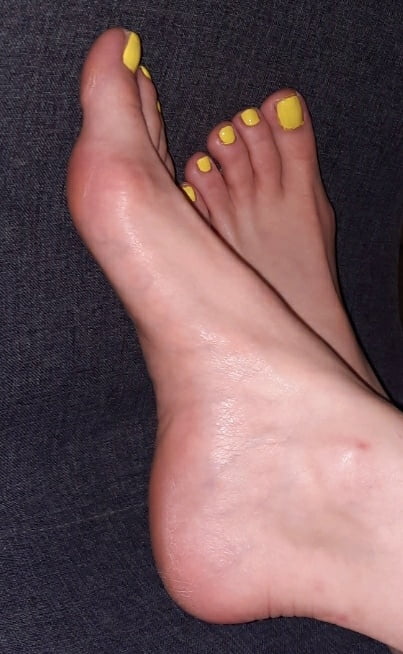 Bare feet, yellow nail polish on her toes - 4 Photos 