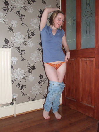 cute blonde posing in jeans and shirt         