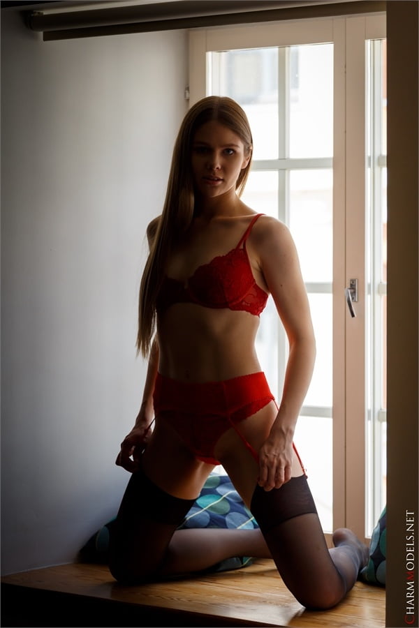 Evelina on the window in red lingerie - 16 Photos 